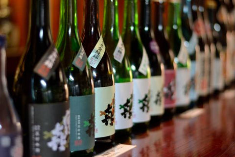A row of premium Japanese sake bottles