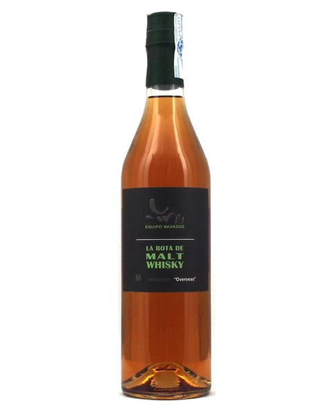 A bottle of Equipo Navazos 'La Bota de Malt Whisky' with amber-colored liquid inside, a black label with green and white text, and a dark green cap, set against a plain white background.