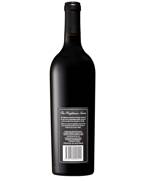 Back of Teusner FG Shiraz. A dark glass wine bottle shown from the back, featuring a black neck wrap and a white rectangular label with text and a barcode. The label reads 'The Righteous Liar' and 'Produced in Australia'.
