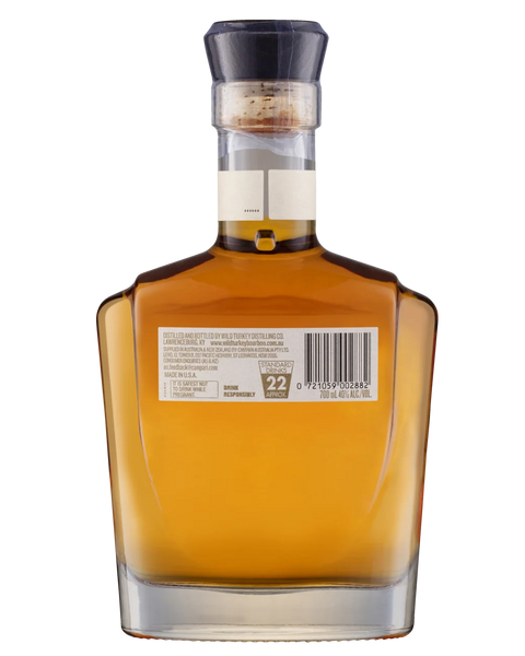 Back view of a square glass bottle of Jim Beam bourbon whiskey with a black cap, showing the amber liquid and a white label with a barcode.